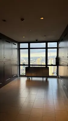 a large room with a bench in a building with large windows at Max 1 Small Pet Allowed! Choose Pet Rate Plan if you have a pet with you! Gramercy Residences at 42nd Floor with Pool and Gym Access in Manila
