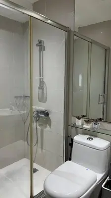 a bathroom with a toilet and a glass shower at Max 1 Small Pet Allowed! Choose Pet Rate Plan if you have a pet with you! Gramercy Residences at 42nd Floor with Pool and Gym Access in Manila