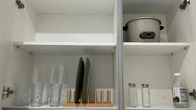 a white cabinet with some kitchen utensils in it at Max 1 Small Pet Allowed! Choose Pet Rate Plan if you have a pet with you! Gramercy Residences at 42nd Floor with Pool and Gym Access in Manila