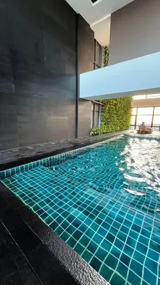 a swimming pool with blue tiles in a building at Max 1 Small Pet Allowed! Choose Pet Rate Plan if you have a pet with you! Gramercy Residences at 42nd Floor with Pool and Gym Access in Manila