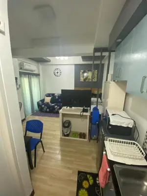 a small room with a kitchen and a living room at 19f w NFLIX & BALCONY NEAR ROB, PGH, ACC USM&SLMC in Manila