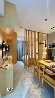 a room with a dining table and a bedroom at MODERN ZEN Den in Manila