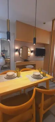 a dining room table with plates and a mirror at MODERN ZEN Den in Manila
