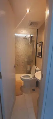 a bathroom with a toilet and a sink at MODERN ZEN Den in Manila