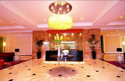 a lobby with a table and a chandelier at MODERN ZEN Den in Manila