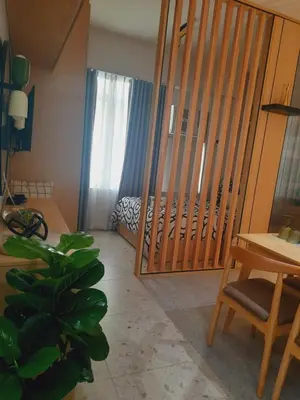a room with a bedroom with a bed and a wooden gate at MODERN ZEN Den in Manila