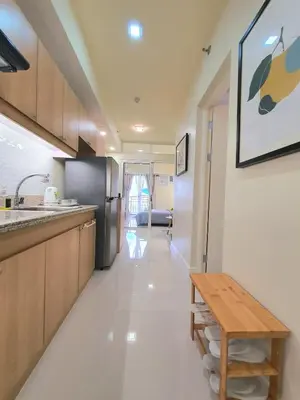 a kitchen with a wooden bench and a table at Lovely, Cozy One Bedroom with Wi-fi Pool in Pasig in Manila