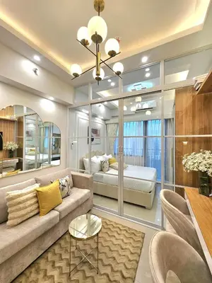 a living room with a couch and a bed at Franchelle Bliss - Shore 2 Residences Tower 1 in Manila