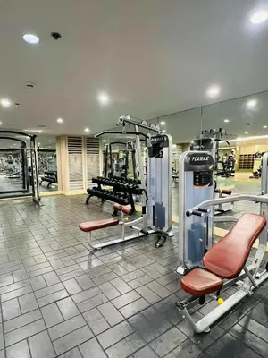 a gym with treadmills and chairs in a room at Franchelle Bliss - Shore 2 Residences Tower 1 in Manila