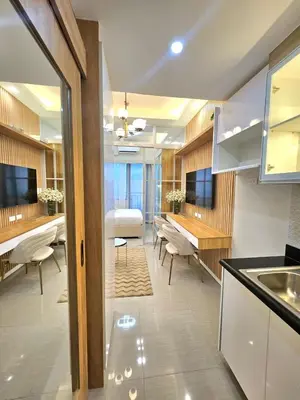 a kitchen and dining room with a table and a dining room at Franchelle Bliss - Shore 2 Residences Tower 1 in Manila