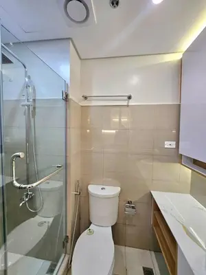 a bathroom with a toilet and a glass shower at Franchelle Bliss - Shore 2 Residences Tower 1 in Manila