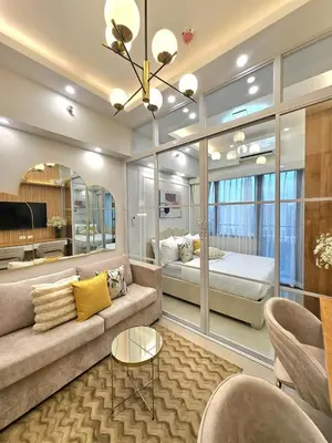 a living room with a couch and a bed at Franchelle Bliss - Shore 2 Residences Tower 1 in Manila