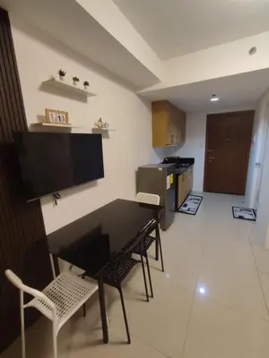 a kitchen with a table and chairs in a room at Newly Renovated Shell Residences Mall of Asia Condo in Manila