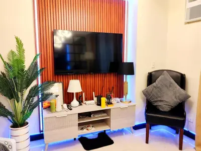 a room with a desk with a tv and a chair at Velvet Accommodation PH in Manila