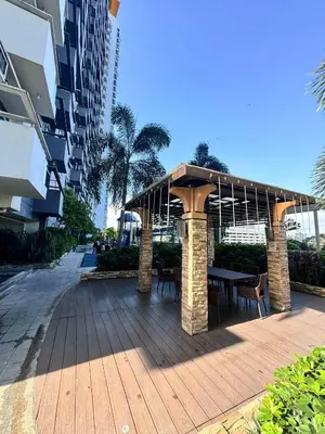a gazebo with a table and chairs on a wooden deck at Velvet Accommodation PH in Manila