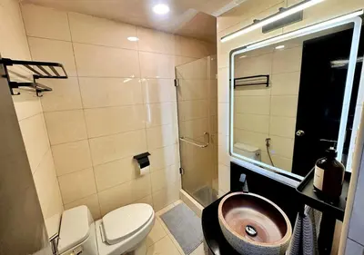 a bathroom with a sink and a toilet and a shower at Hestia Homes near Airport in Manila