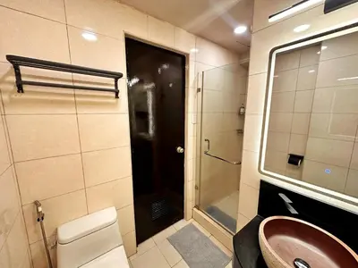 a bathroom with a sink and a shower and a mirror at Hestia Homes near Airport in Manila