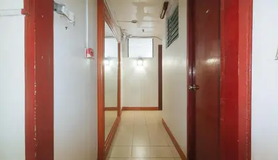 a corridor of an office building with a hallway at Stay Malate Hostel by RedDoorz in Manila