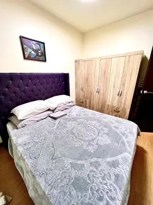 a bedroom with a purple bed and a wooden cabinet at Condo unit in Sucat, Paranaque Calathea Place in Manila