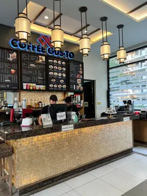 two people sitting at the counter of a coffee shop at Condo unit in Sucat, Paranaque Calathea Place in Manila