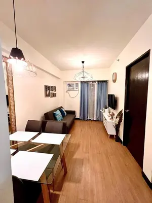 a living room with a couch and a table at Condo unit in Sucat, Paranaque Calathea Place in Manila