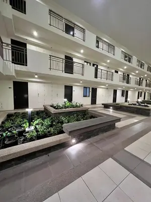 a large building with a bunch of plants in it at Condo unit in Sucat, Paranaque Calathea Place in Manila