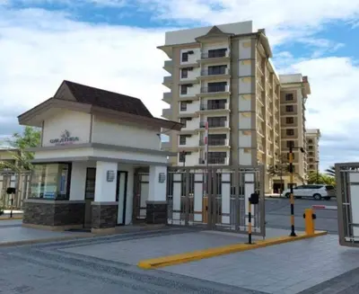 a building on a street next to a building at Condo unit in Sucat, Paranaque Calathea Place in Manila
