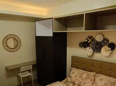 a bedroom with a bunk bed and a mirror at Cozy Crib2 in Manila