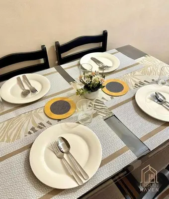 a table with white plates and silver utensils on it at Staycation in Alabang in Manila