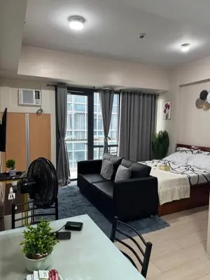 a living room with a bed and a couch at 81 Newport Boulevard Condominium across International Airport Terminal 3 C1-4C in Manila