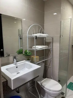 a bathroom with a sink and a toilet and a mirror at 81 Newport Boulevard Condominium across International Airport Terminal 3 C1-4C in Manila