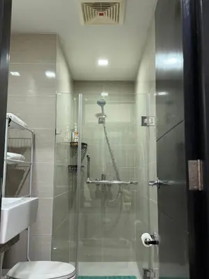 a bathroom with a shower and a toilet and a sink at 81 Newport Boulevard Condominium across International Airport Terminal 3 C1-4C in Manila