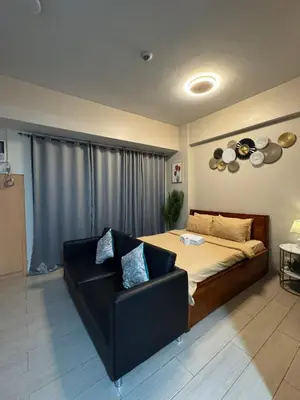a living room with a bed and a couch at 81 Newport Boulevard Condominium across International Airport Terminal 3 C1-4C in Manila