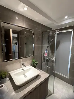 a bathroom with a sink and a shower at Spacious Apartment Hotel near City of Dreams, Airport, MOA, Okada, Ayala Malls, and Solaire Casino with free 5 pool access in Manila