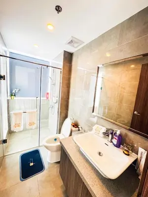 a bathroom with a sink and a toilet and a shower at Spacious Unit & High-Floor Hotel near City of Dreams, Airport, Okada, and Solaire Casino in Manila