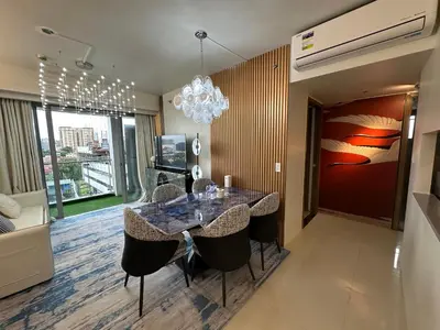 a dining room with a table with chairs and a chandelier at Spacious Unit & High-Floor Hotel near City of Dreams, Airport, Okada, and Solaire Casino in Manila