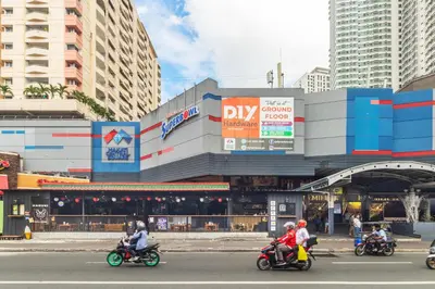 a group of people riding motorcycles on a city street at Kintai Suites at the Beacon in Manila