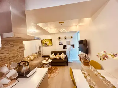 a living room with a couch and a table at 2br in Azure with Manila Bay View & Laguna de Bay View in Manila