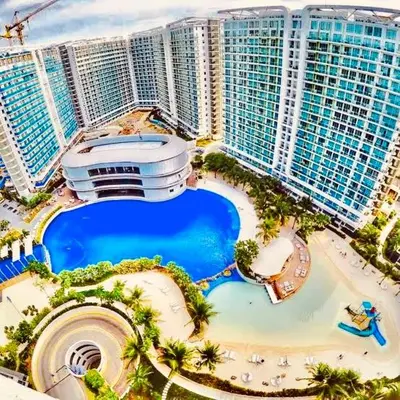 an aerial view of a resort with a pool at 2br in Azure with Manila Bay View & Laguna de Bay View in Manila