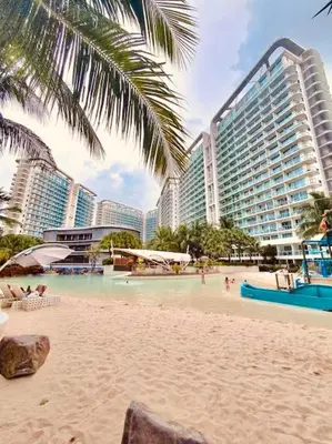 a beach with some people and some buildings at 2br in Azure with Manila Bay View & Laguna de Bay View in Manila