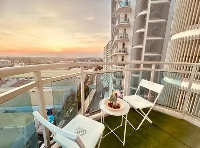 a balcony with chairs and a table on a building at 2br in Azure with Manila Bay View & Laguna de Bay View in Manila