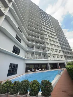 a large apartment building with a swimming pool at MAKATI - Lush Residences in Manila