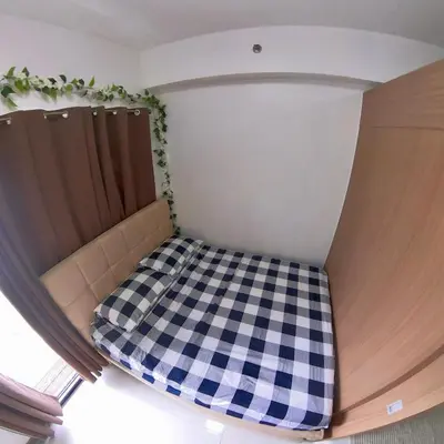 a bed in a room with a checkered floor at MAKATI - Lush Residences in Manila