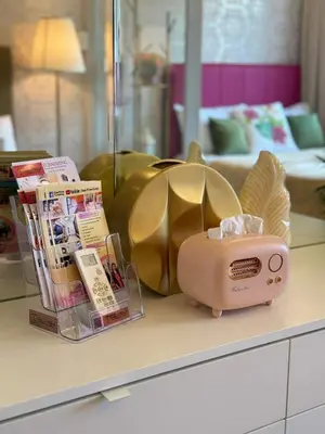 a table with a pink toaster and magazines on it at Shore Residences Sunset Room facing Manila Bay & City View RM1641 by Prime Stay MOA in Manila