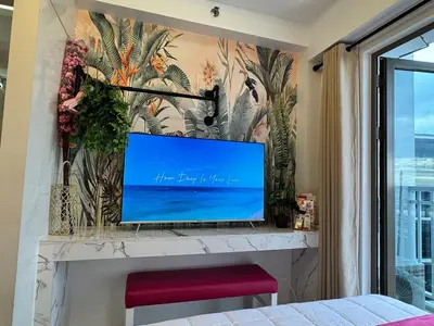 a flat screen tv sitting on a fireplace in a room at Shore Residences Sunset Room facing Manila Bay & City View RM1641 by Prime Stay MOA in Manila