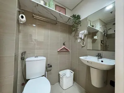 a bathroom with a toilet and a sink at Shore Residences Sunset Room facing Manila Bay & City View RM1641 by Prime Stay MOA in Manila