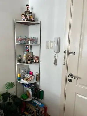 a shelf with toys on it next to a door at Serenity Escapes by Aj in Manila