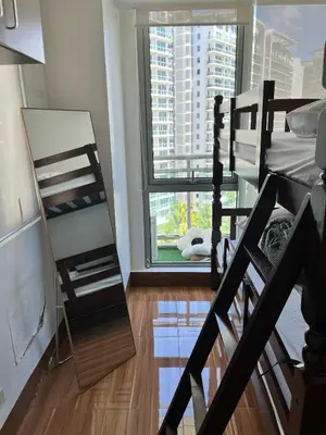 a bedroom with a bunk bed and a window at Serenity Escapes by Aj in Manila