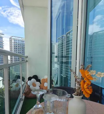 a balcony with a table with a view of a city at Serenity Escapes by Aj in Manila