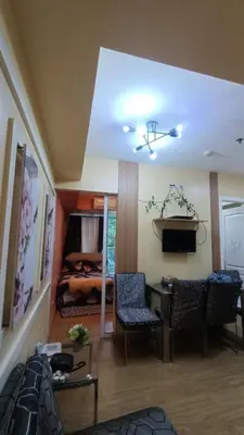a living room with a couch and a table and a bed at Joy Azure Escapes in Manila